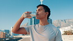 City, man and fitness with drinking water for health, hydration and break for marathon challenge. Outdoor, male person and runner with thirst for h2o liquid, nutrition or detox after wellness workout