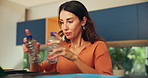 Woman, box and bottle in trash at house for recycling, change and waste management. Female person, pick up plastic and hygiene of reusable garbage, disposal container and environment responsibility