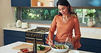 Kitchen counter, woman and salad with vegetables, mixing and healthy diet for lunch and nutritionist. Home, vegan and person with culinary skills for cuisine, process and flavor with ingredients