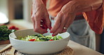 Kitchen counter, hands and salad with vegetables, meal prep and healthy diet for lunch and nutrition. Home, nutritionist and person with process for cuisine, vegan or culinary skills with ingredients
