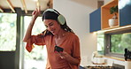 Dancing, headphones and woman with cellphone in kitchen with spoon for music, fun or entertainment. Energy, phone and female person moving with audio tech for playlist, album or radio online in home.