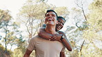 Couple, laugh and piggyback for fitness in nature for exercise, fun training and playful break. Smile, people and hug with relationship, romance and bonding together for sightseeing of travel workout