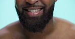 Closeup, mouth and man in studio, smile and teeth whitening on blue background. Happy person, lips and model with beard grooming, oral health and beauty with wellness, dental care and treatment