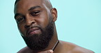 Face, styling and man with beard, comb and tangle prevention with tool, smile and grooming in morning. Blue background, studio and black person with routine for hygiene, space and facial treatment