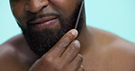 Hands, studio and man with beard, comb and tangle prevention with tool, smile and grooming in morning. Blue background, styling and black person with routine for hygiene, mouth and facial treatment