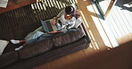 Break, laptop and woman on sofa in living room of home from above for holiday or vacation booking. Computer, morning and relax with person on couch in apartment to search for hotel accommodation