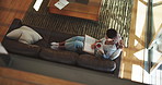Book, coffee and woman on sofa in living room of home from above for rest, weekend or wellness. Break, reading and vacation with mature person drinking caffeine beverage on couch in apartment