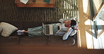 Laptop, living room and yawn of woman on sofa in home from above for holiday or vacation booking. Break, computer and relax with tired person on couch in apartment to search for hotel accommodation