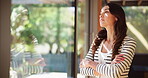 Anxiety, arms crossed and window with woman in living room of home for depression, mistake or regret. Reflection, stress and thinking with mature person in apartment for frustration or disappointment