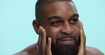 Skincare, moisturizing and man with beard, studio and grooming with cosmetics in morning, smile and confident. Blue background, fresh shave and black person with routine for self care and happy