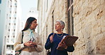 Conversation, paper and walking with lawyer women outdoor in city for court case preparation. Documents, talking and teamwork with advocate people in urban town for discussion of legal trial