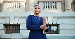 Mature woman, face and lawyer with documents in city for court justice or legal law service. Portrait, female person or professional attorney with folder or confidence for testimony or case in town