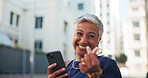 Mature woman, face and city with phone or finger heart for app, online connection or communication. Portrait, female person or wink with smile or emoji on mobile smartphone for love in an urban town