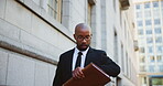 City, time and walking with black man lawyer outdoor as legal council for court case or trial. Folder, schedule and watch with attorney at law in urban town for commute to appointment as advocate