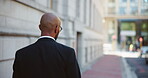 Walking, back and business man in city for attorney, legal representative or professional. Corporate lawyer, solicitor or advisor with person outdoor for advocate consultant and courtroom appointment