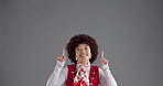 Pointing, happy and face of woman in studio for marketing, announcement or choice by mockup space. Excited, presentation and portrait of female person with decision for advertising by gray background