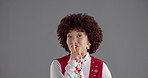 Woman, finger and quiet in studio with face, vintage style and secret for disco by background. Girl, person and sign by lips in portrait for privacy, gossip and fashion for retro event in Costa Rica