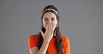 Face, laughing and surprise with woman in studio for expression, good news or gossip. Emoji, energy and wow with funny person isolated on gray background for announcement, information or promotion