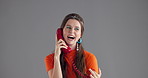 Woman, talking and retro telephone in studio with smile for story, gossip or conversation by background. Girl, phone call and happy for discussion, contact or laugh at funny joke with vintage fashion