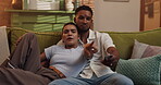 Pointing, relax and television with couple on sofa in living room of home for streaming service. Comedy, laughing and watching tv with people in apartment together for entertainment or subscription