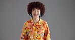 Face, fashion and smile of woman in studio on gray background for funky or retro style. Afro, excited and summer clothing with happy model laughing in colorful outfit for comedy, humor or joke