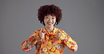 Happy woman, face and thumbs up with afro in studio for fashion or style on a gray background. Portrait, female person or model with smile, like emoji or yes sign for good job or well done on space