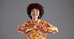 Happy woman, face and studio with heart hands for love, care or kindness on a gray background. Portrait, female person or model with smile, emoji or romantic gesture for shape or icon on mockup space