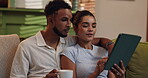 Browsing, couple and watching movies on tablet, choice and bonding with entertainment in living room. House, streaming and people with tech for film, woman and man in lounge, chilling and apartment