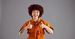 Happy woman, face and studio with thumbs up for winning, good job or well done on a gray background. Portrait, female person or model with smile, like emoji or yes sign for promotion or thank you