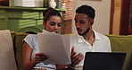 Frustrated couple, fighting and documents with laptop for financial crisis or debt review on sofa at home. Upset, man or woman with paperwork, bills or expenses on computer for bankruptcy at house
