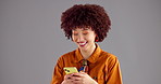 Happy woman, typing and studio with phone for communication or social media on a gray background. Female person, model or user with smile on mobile smartphone for online chatting or texting on space