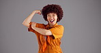 Wink, muscle and face of woman in studio for empowerment, strength and confidence. Happy, champion and portrait of person with strong arm flex for power, pride and achievement on gray background