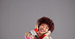 Woman, headphones and music with student, dancing and fun with energy and listen to radio on grey background. Tech, mockup space and dancer in studio with audio, streaming and techno sound for hobby