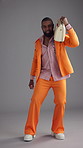 Music, radio and fashion with face of black man in studio for retro style, funky vibe and bohemian culture. Groovy streaming, indie aesthetic and disco dancer with person on gray background for sound