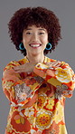 Face, dancing and woman with fashion, retro clothes and confidence on gray background. Person, dancer and vintage outfit with movement, stylish wardrobe and smile with pride,  unique and colourful