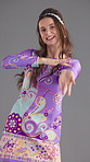 Dancer, groovy and fashion with face of woman in studio for retro style, funky vibe and bohemian culture. Paisley dress, indie aesthetic and disco music with person on gray background for energy