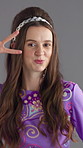 Face, dancing and woman with fashion, smile and peace sign with confidence on gray background. Person, model and vintage outfit with symbol, stylish wardrobe and retro clothes with pride or colourful