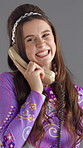Girl, chat and retro telephone in studio with smile for story, gossip and disco style by background. Woman, phone call and happy for discussion, contact and laugh at comic joke with vintage fashion