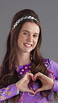 Happy, heart hands and face of woman in studio with kindness, support or care gesture. Smile, icon and portrait of person from London with love emoji for gratitude or positivity by gray background.