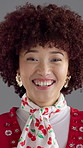 Face, funny and woman in studio, smile and fashion with confident personality on gray background. Portrait, happy person and model with pride, wellness and dental health with humor, laugh and joke