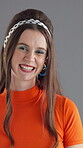 Face, woman and makeup with retro fashion, happiness and confidence with colorful eyeshadow on gray background. Smile, portrait and female person with vintage style or stylish accessories in studio