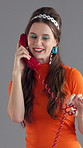Woman, retro telephone and talk for fashion, style and funky makeup with communication on gray background. Phone call, landline and happy person with vintage tech, outfit or stylish clothes in studio