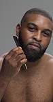 Self care, studio and man with comb for beard, grooming and maintenance of hair, face and morning. Gray background, styling and black person with routine for hygiene, treatment and prevention of itch