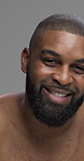 Studio, black man and face with laughing for skincare, grooming and beauty with cosmetics treatment. Portrait, male person and model glow with dermatology for self care, hygiene and gray background