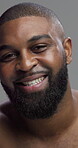 Studio, black man and face with glow for skincare, grooming and beauty with cosmetics treatment. Portrait, male person and model with dermatology for self care, hygiene wellness and gray background