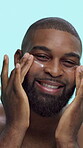 Black man, smile and cream on face in studio for skincare, cosmetics or moisturizer on blue background. Happy, portrait and male person with lotion, sunscreen or facial treatment for dermatology
