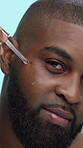 Black man, face and serum with dropper in studio, skincare or cosmetic product with oil on blue background. Portrait, facial essence or hyaluronic acid for dermatology, skin wellness and collagen