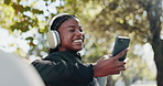Headphones, fitness and black woman with phone in park for exercise, workout and training. Happy, relax and person typing on smartphone for social media, internet and online conversation outdoor