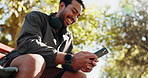 Man, phone and happy on park bench with fitness, rest and chat on web with low angle in summer. Person, smartphone and laugh at funny meme on mobile app, break and social media at training in Mexico