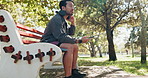 Man, phone and headphones on park bench with fitness, rest or chat on web with inspiration in summer. Person, smartphone and listen to music on mobile app, break or social media at training in Mexico